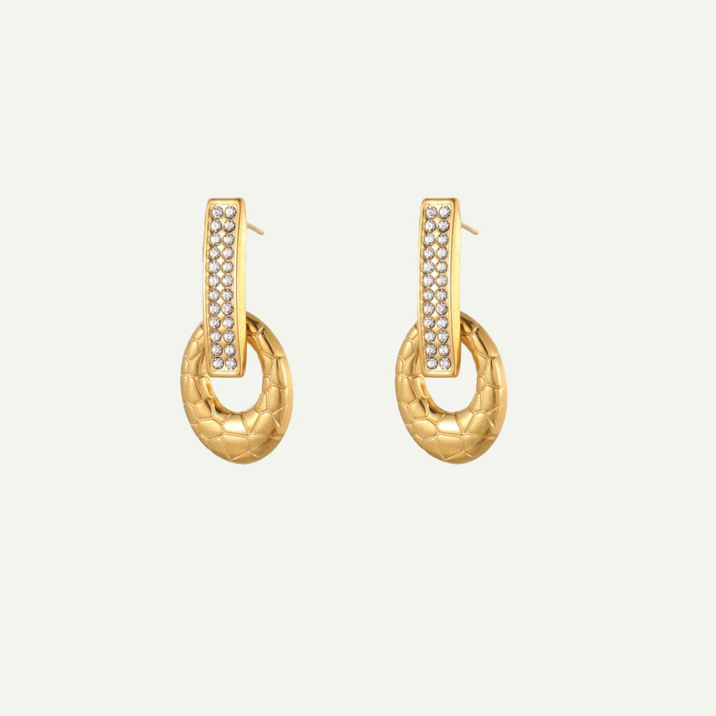 Gold hoop earrings with embedded stones on a white background